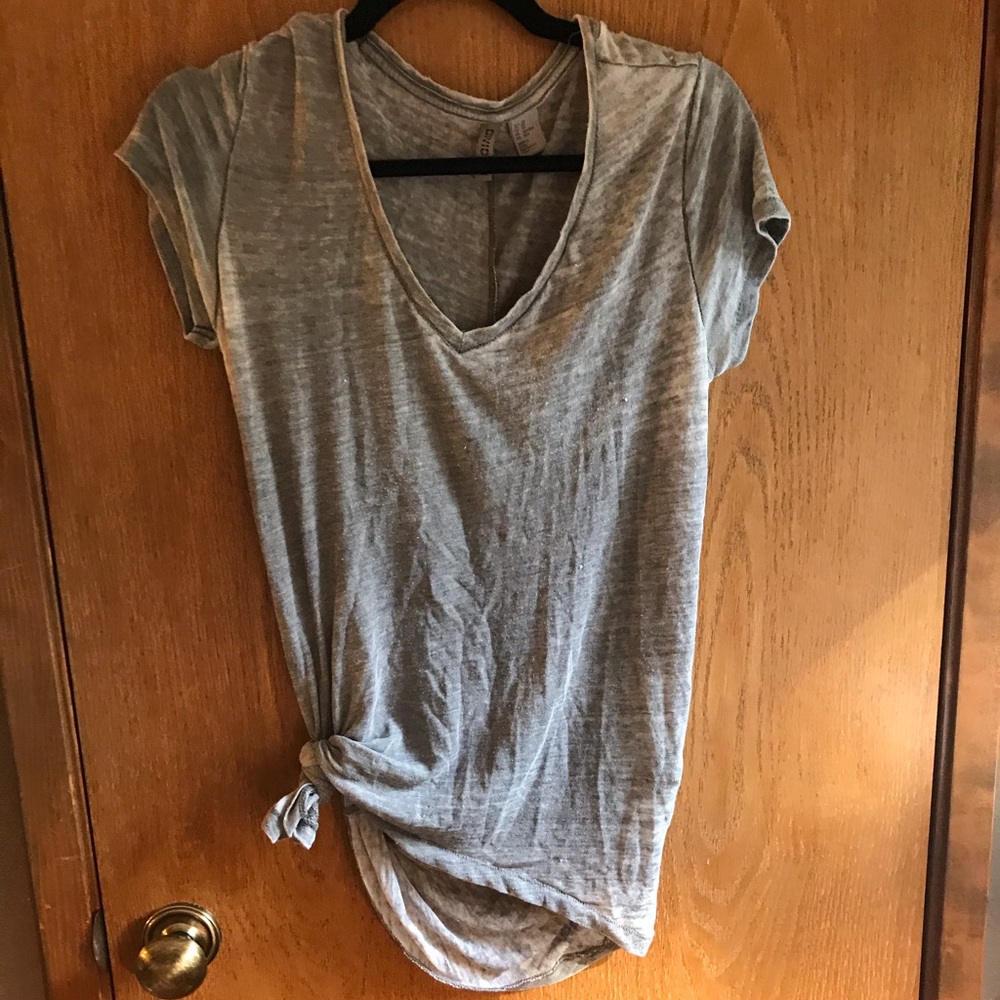 Plain grey T-shirt with simple tie in the front.